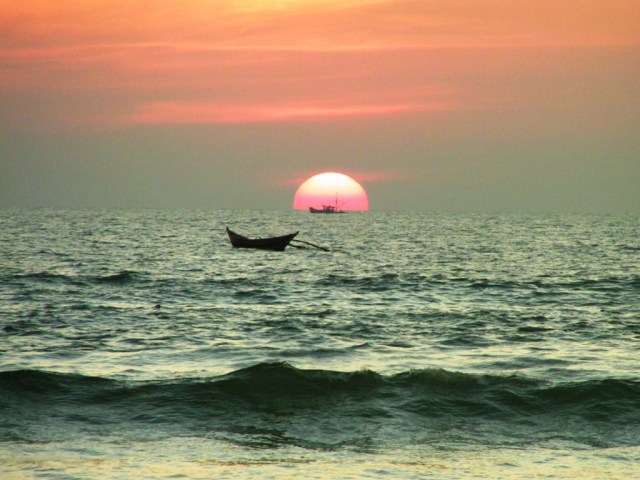 A boat crossing the sunset, Goa, India